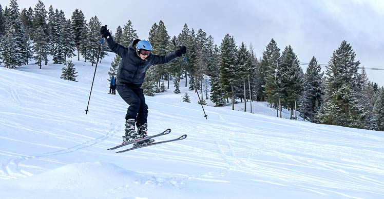 kid jumping over a ski jump