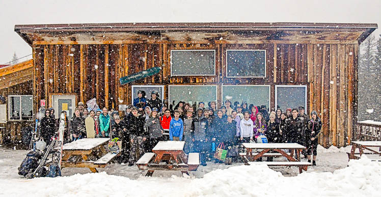 students standing in front of the lodge