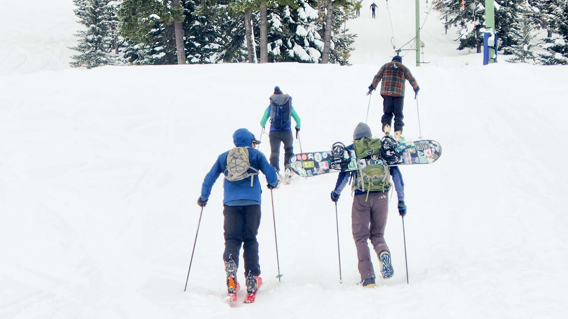 Four men climbing up Fergi on skis